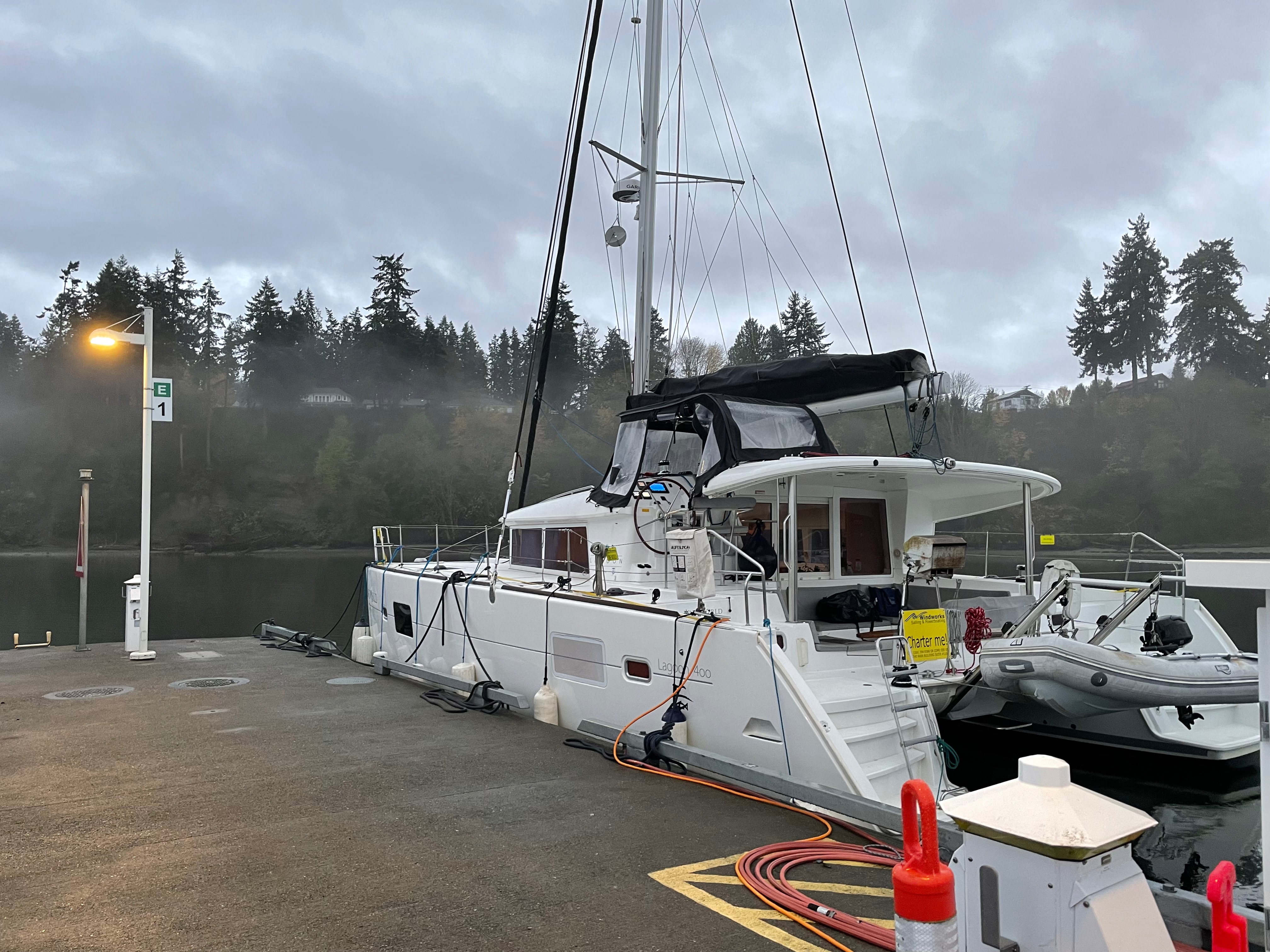 docked catamaran in the fog