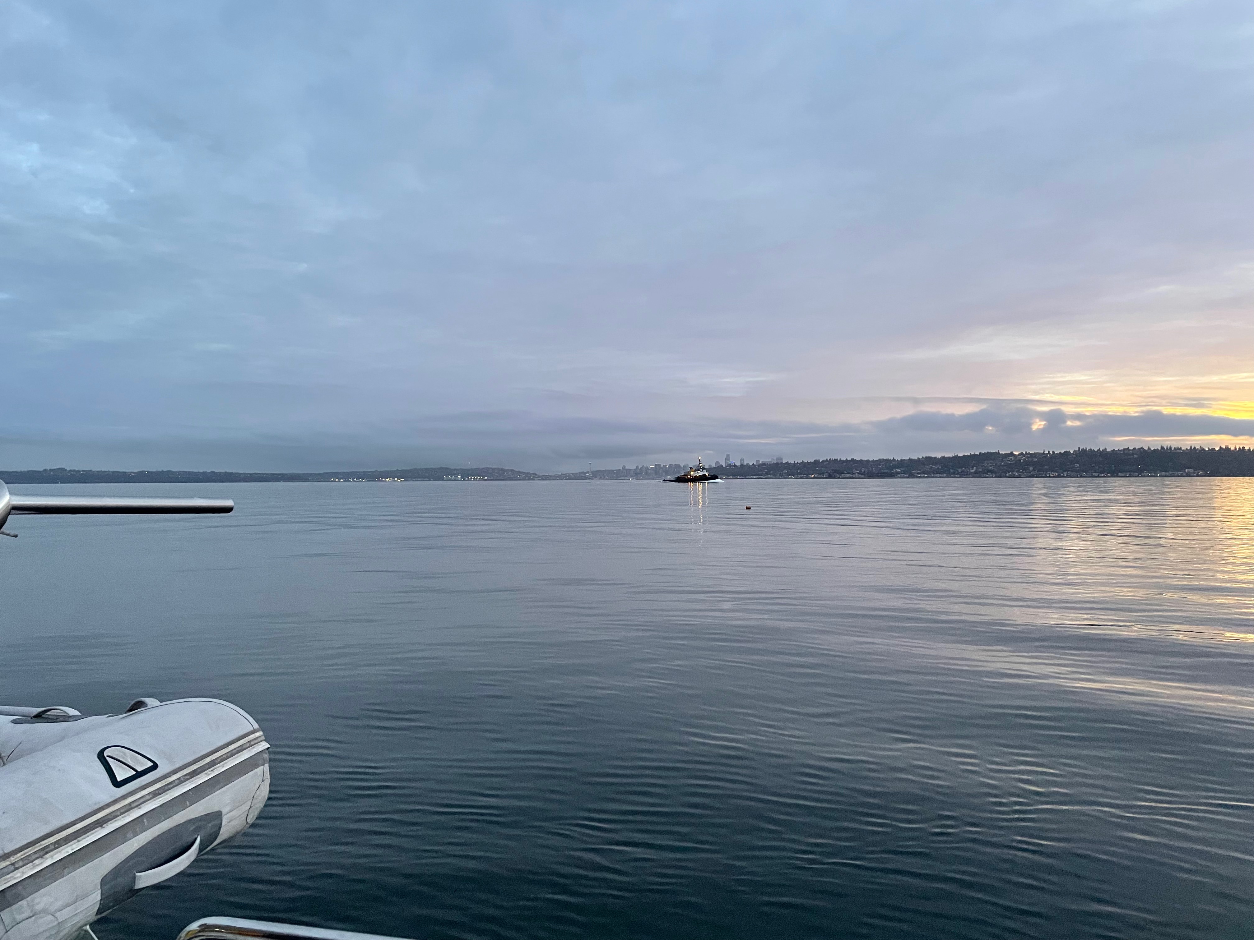 tugboat in front of seattle during sunrise