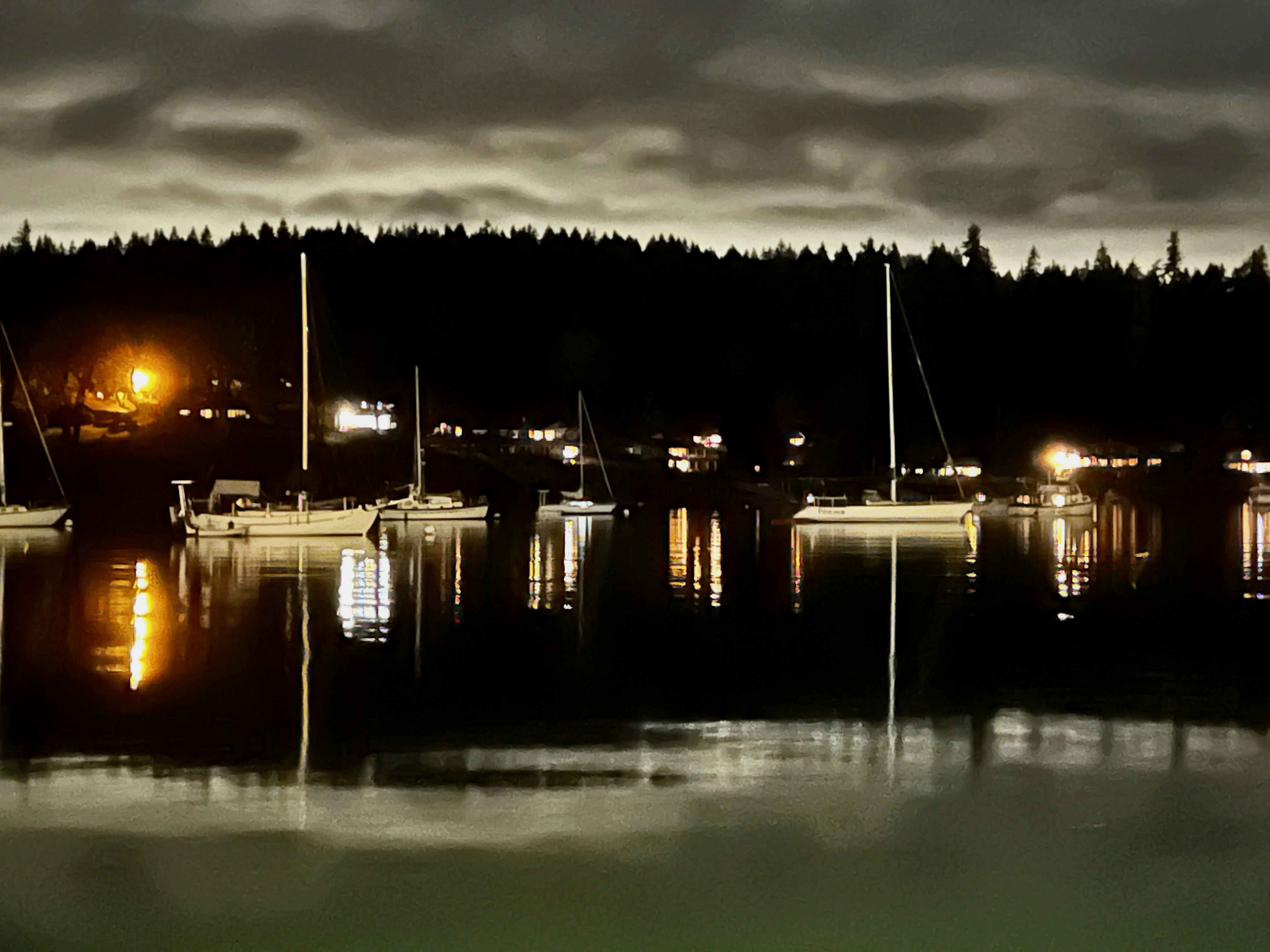 sailboats moored in twilight