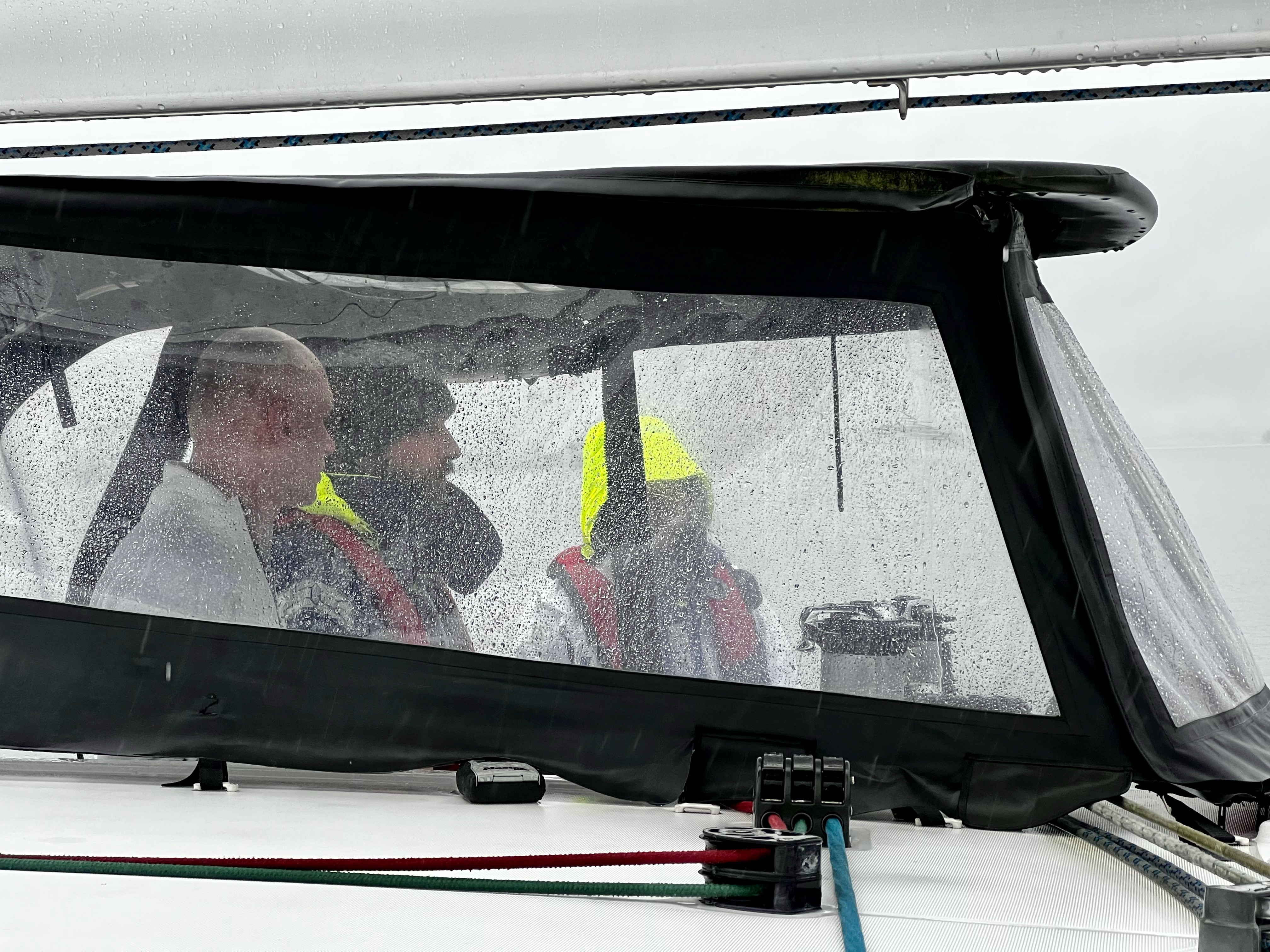 rain-soaked windows in the cockpit of a boat